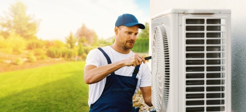 Technician,Working,On,House,Air,Conditioning,Or,Heat,Pump,Outdoor